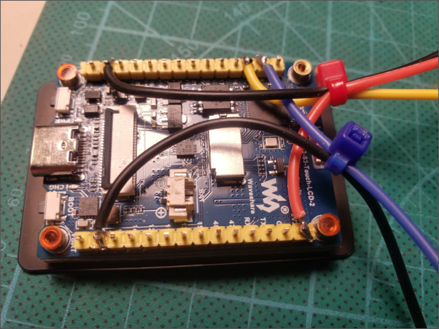 Board in case showing zip ties through case walls as cable strain relief